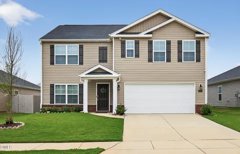 a front view of a house with a yard
