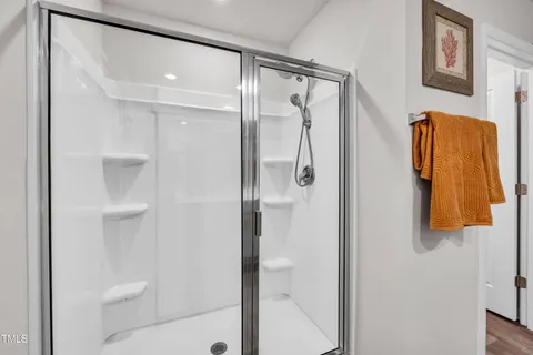 a bathroom with a shower and a glass door