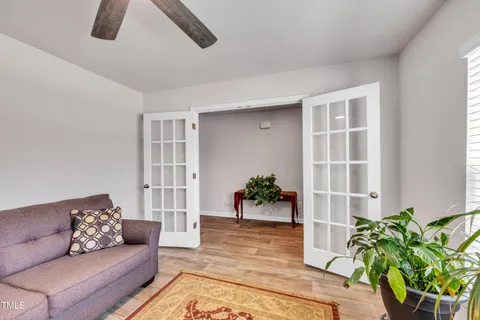 a living room with furniture ceiling fan and a rug