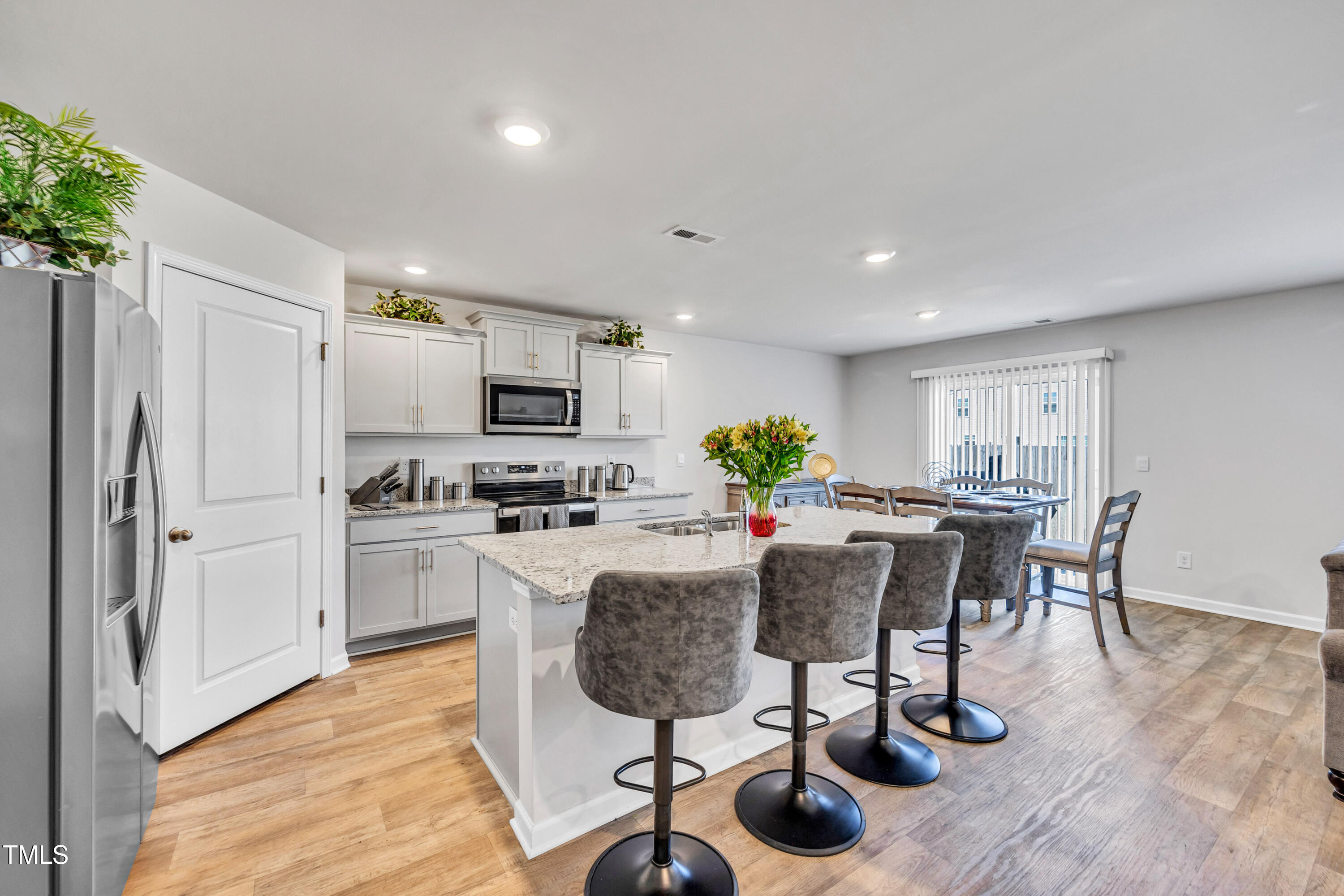 2923 Cullens Drive Graham, NC 27253 - Photo 5 of 48 a view of kitchen with refrigerator microwave stove dining table and chairs