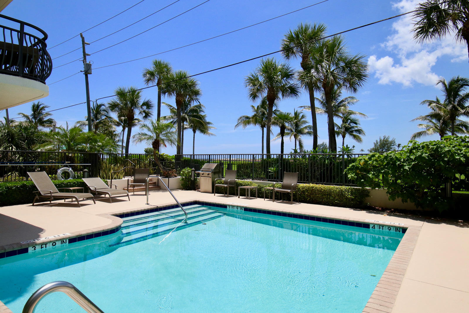 314 Inlet Way, Unit 303 Palm Beach Shores, FL 33404 - Photo 14 of 33 a view of a swimming pool with chairs