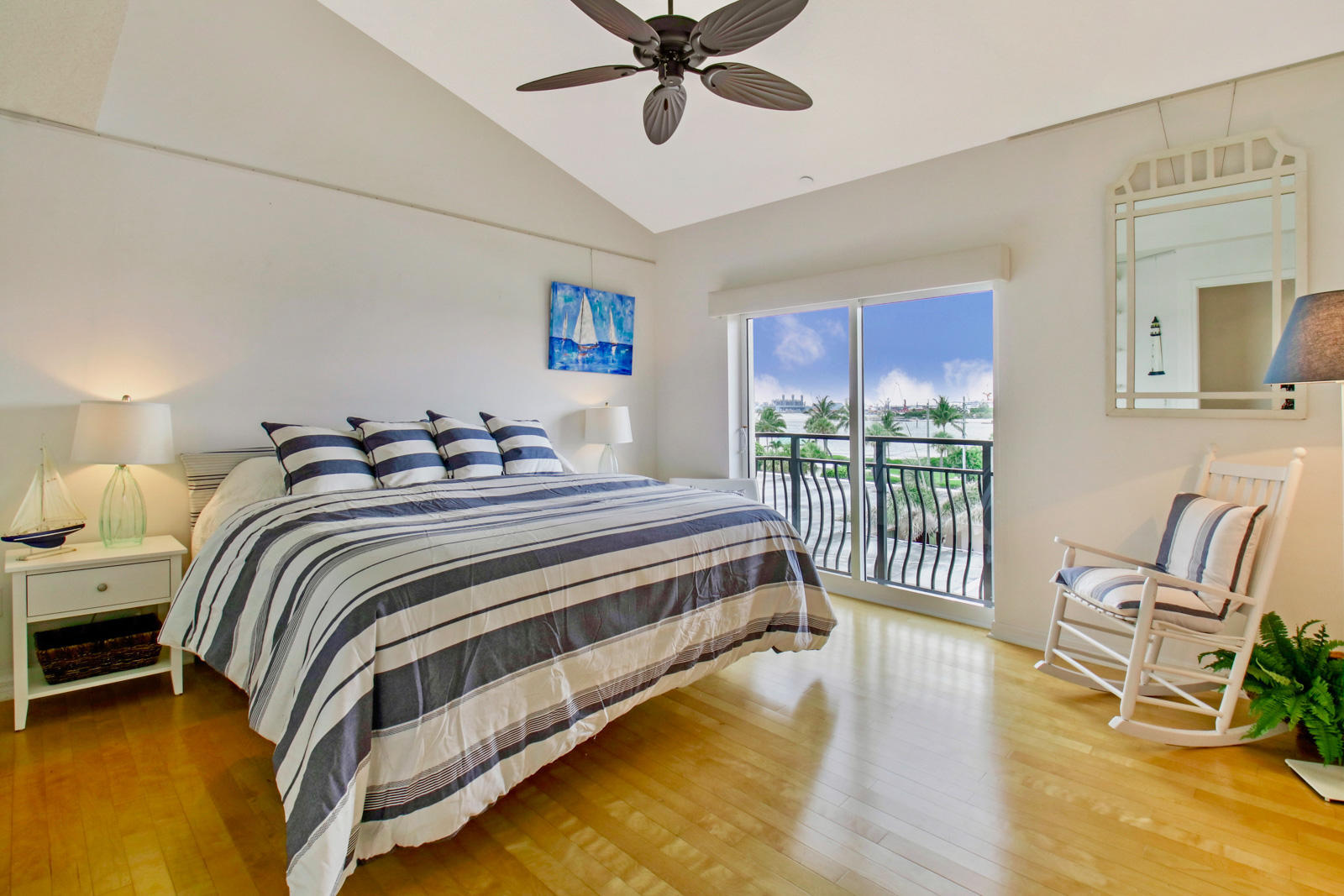 314 Inlet Way, Unit 303 Palm Beach Shores, FL 33404 - Photo 18 of 33 a bedroom with a bed and a view of balcony