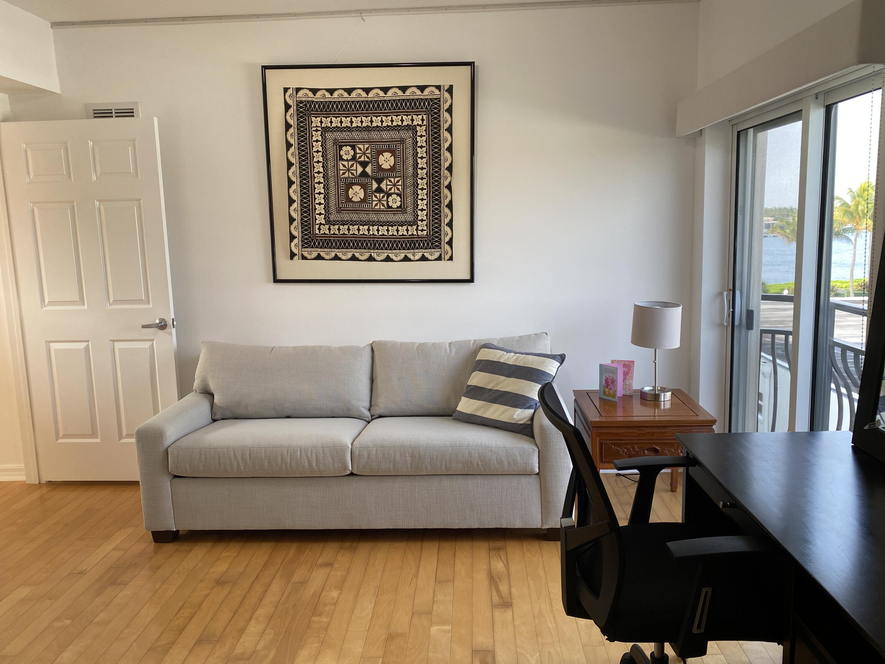 314 Inlet Way, Unit 303 Palm Beach Shores, FL 33404 - Photo 23 of 33 a living room with furniture and a large window