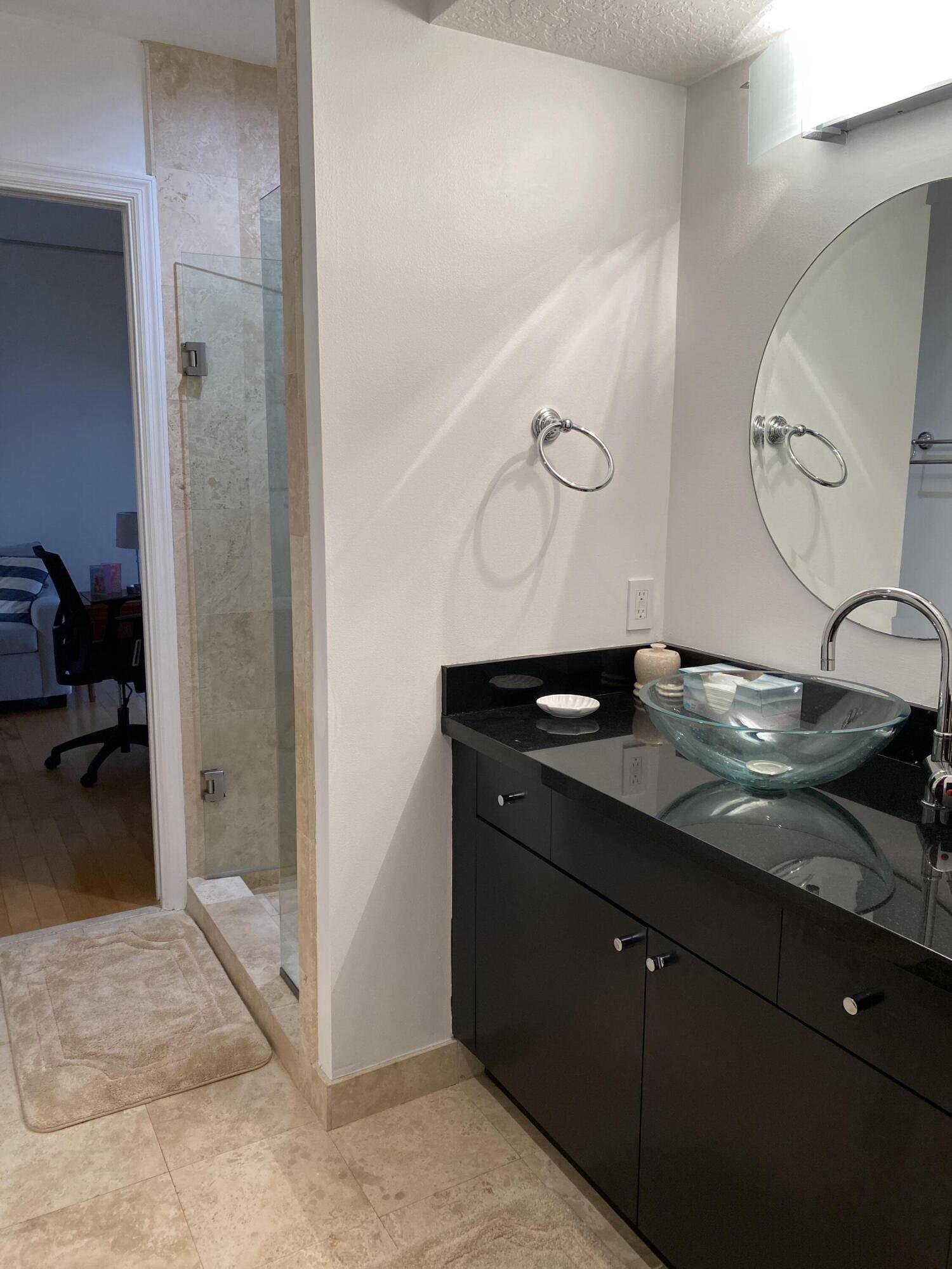 314 Inlet Way, Unit 303 Palm Beach Shores, FL 33404 - Photo 24 of 33 a spacious bathroom with a granite countertop sink and a mirror