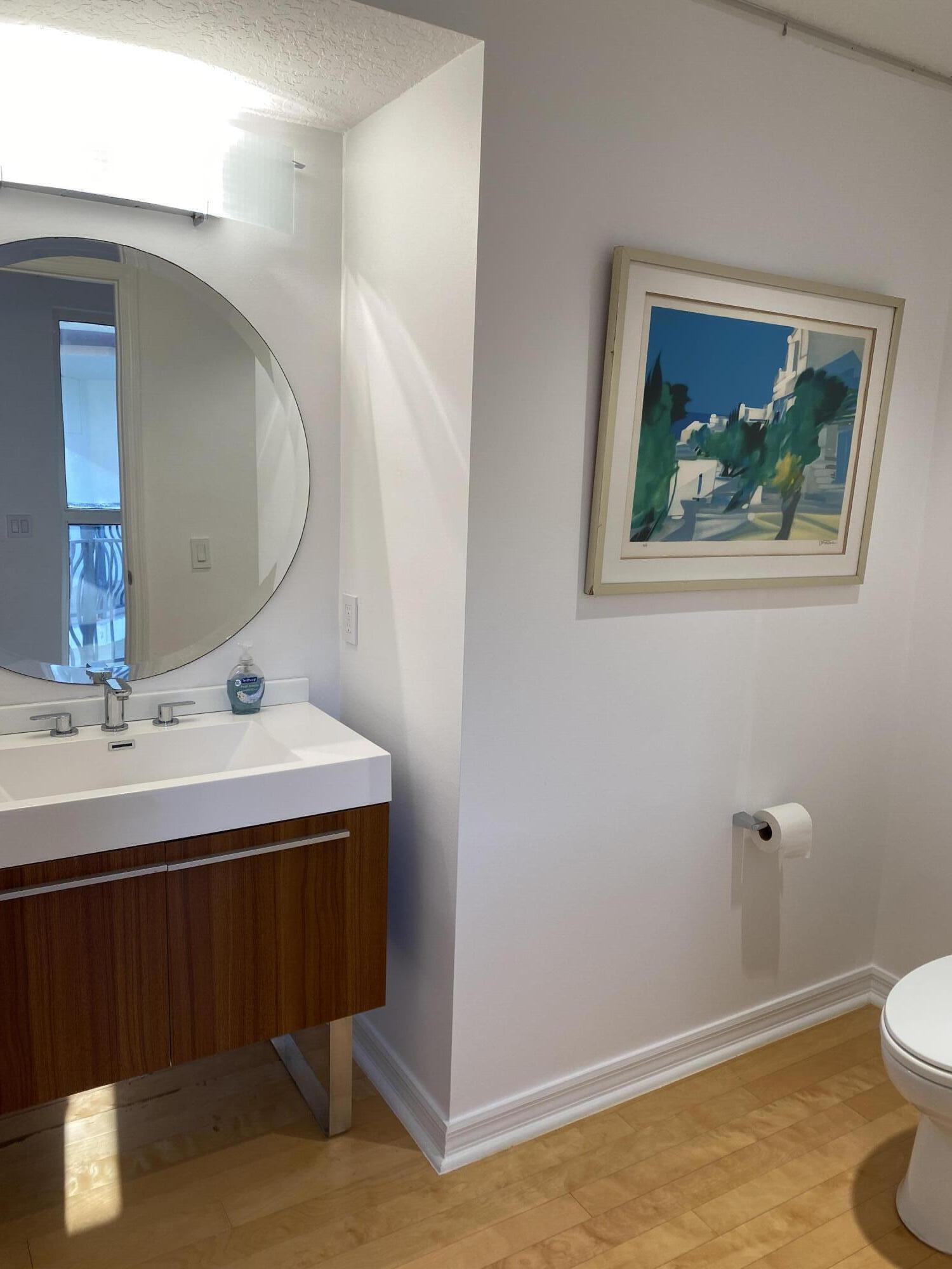 314 Inlet Way, Unit 303 Palm Beach Shores, FL 33404 - Photo 28 of 33 a bathroom with a sink and a mirror