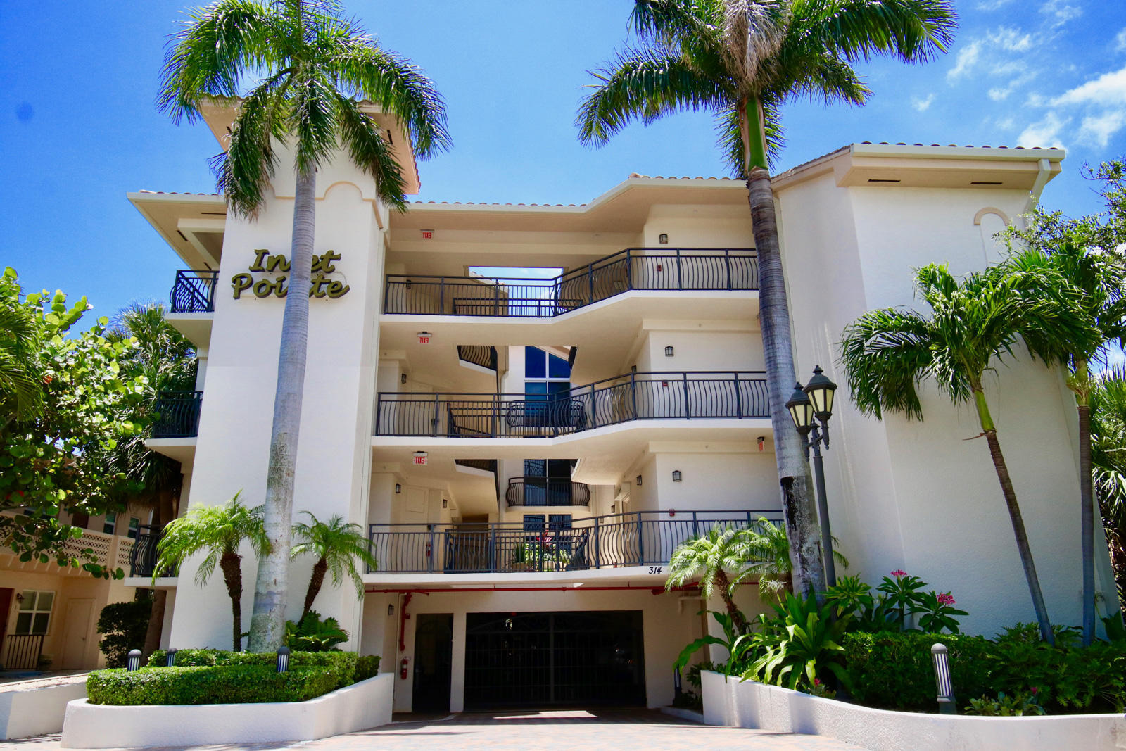 314 Inlet Way, Unit 303 Palm Beach Shores, FL 33404 - Photo 29 of 33 a front view of house with a garden and potted plants