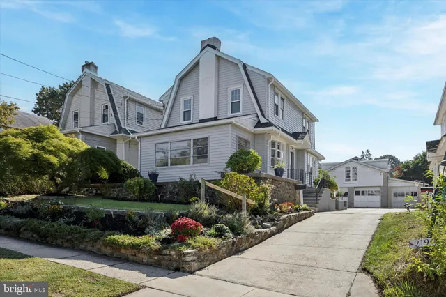a front view of a house with a garden and plants