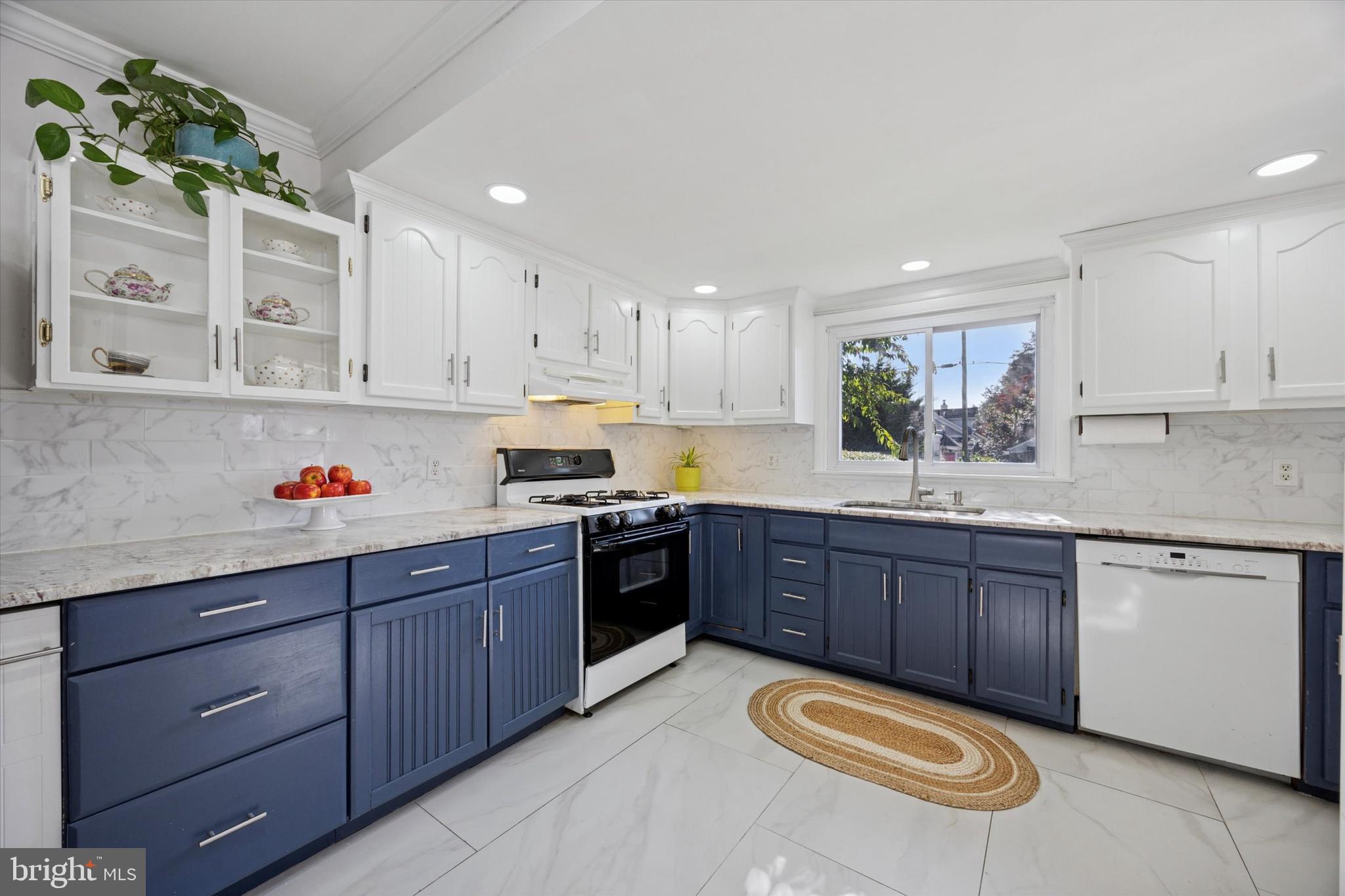 217 Windsor Avenue Upper Darby, PA 19082 - Photo 11 of 36 a kitchen with stainless steel appliances granite countertop a stove sink and cabinets