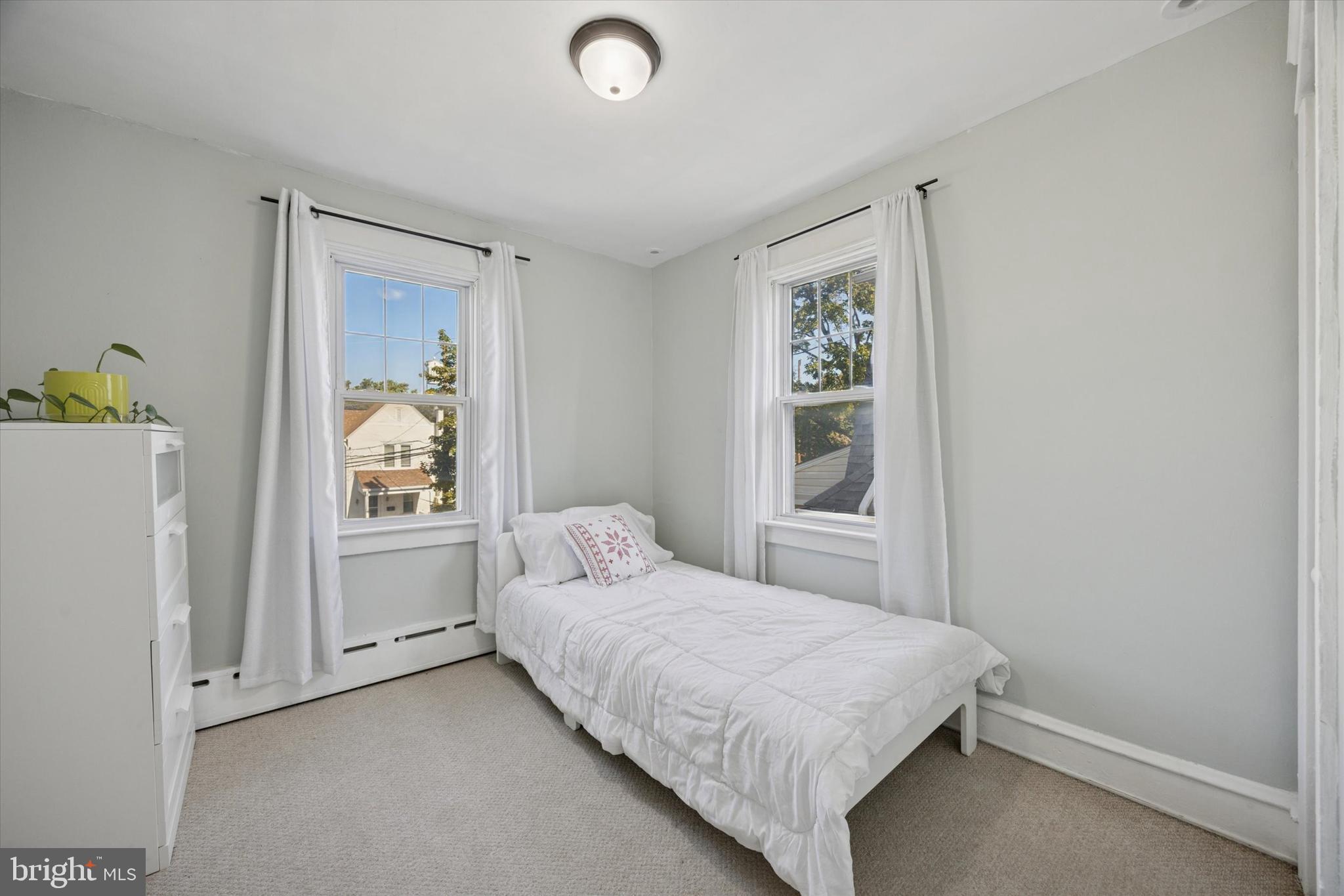 217 Windsor Avenue Upper Darby, PA 19082 - Photo 14 of 36 a bedroom with a bed and a window