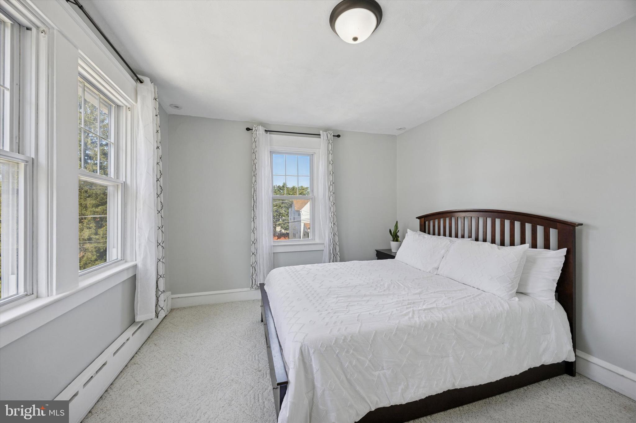 217 Windsor Avenue Upper Darby, PA 19082 - Photo 15 of 36 a bedroom with a large bed and a window