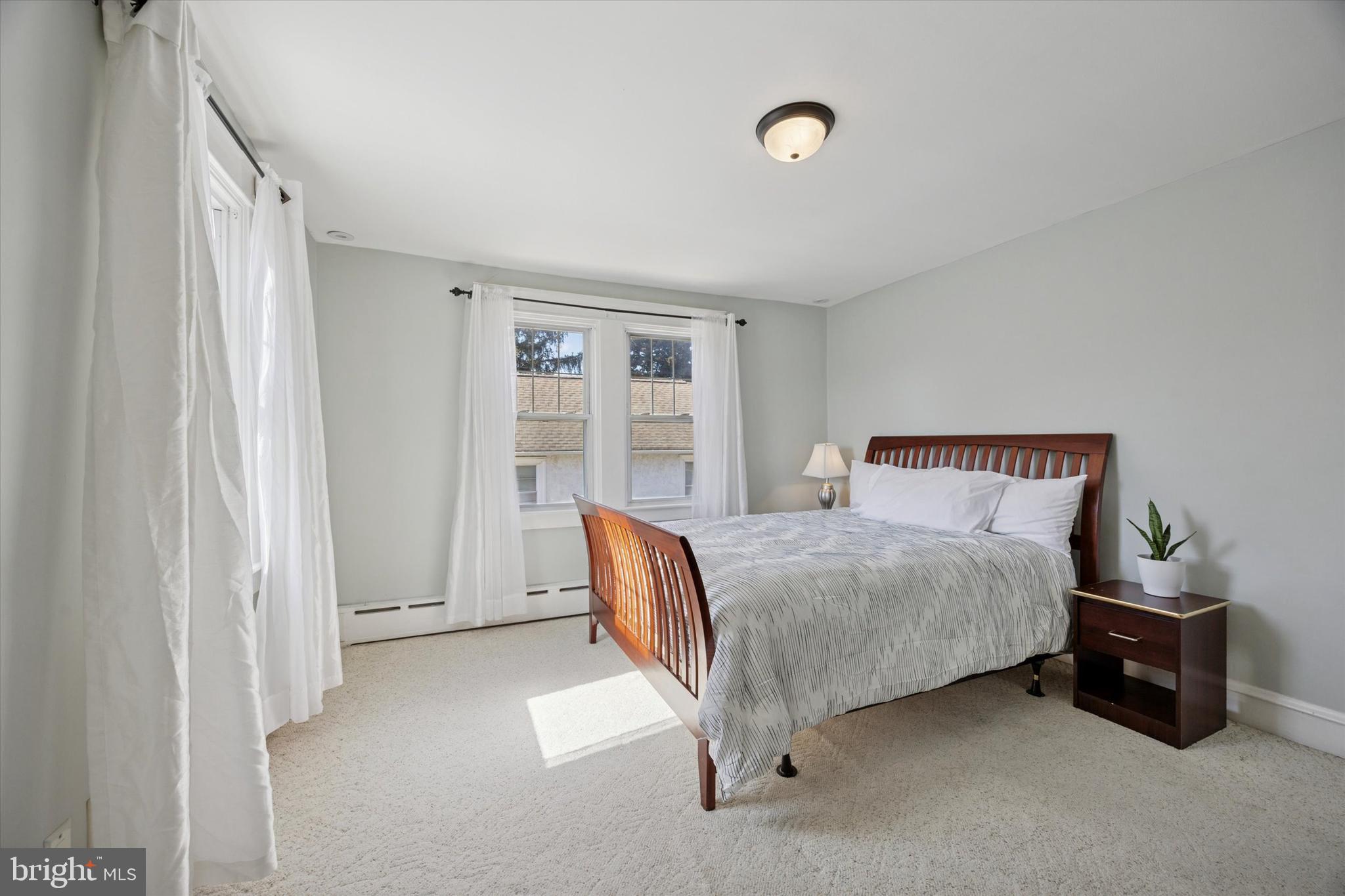 217 Windsor Avenue Upper Darby, PA 19082 - Photo 17 of 36 a bedroom with a bed and a couch