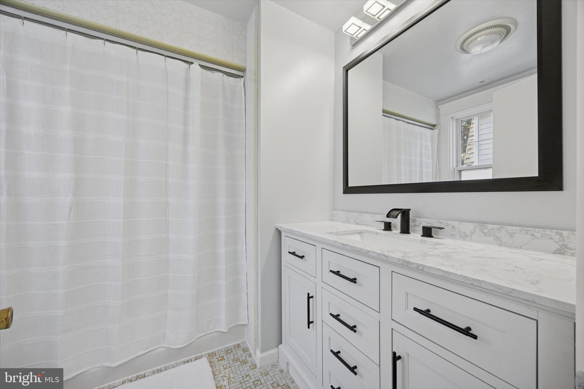 217 Windsor Avenue Upper Darby, PA 19082 - Photo 19 of 36 a bathroom with a sink and a mirror