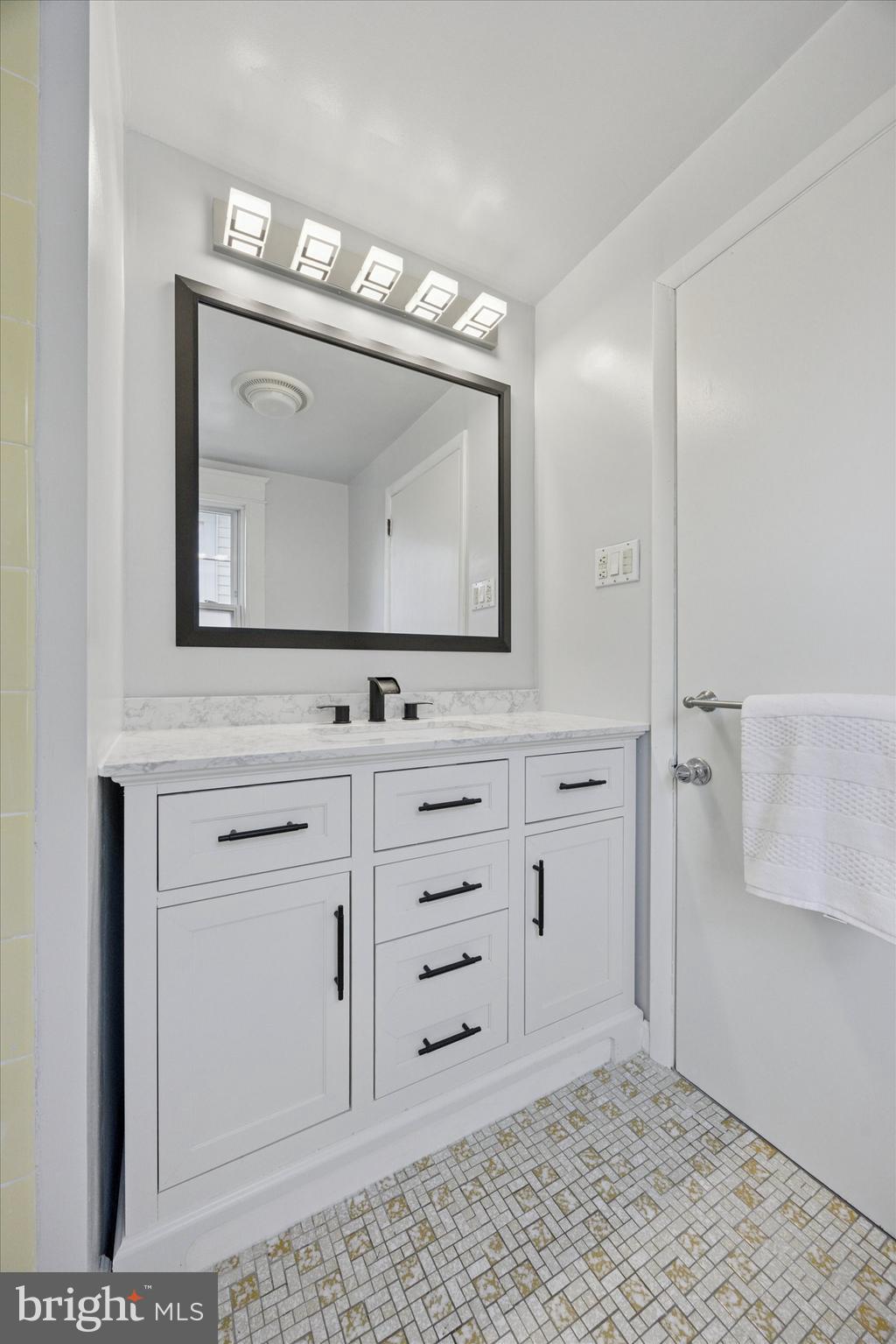 217 Windsor Avenue Upper Darby, PA 19082 - Photo 20 of 36 a bathroom with a mirror sink and cabinets