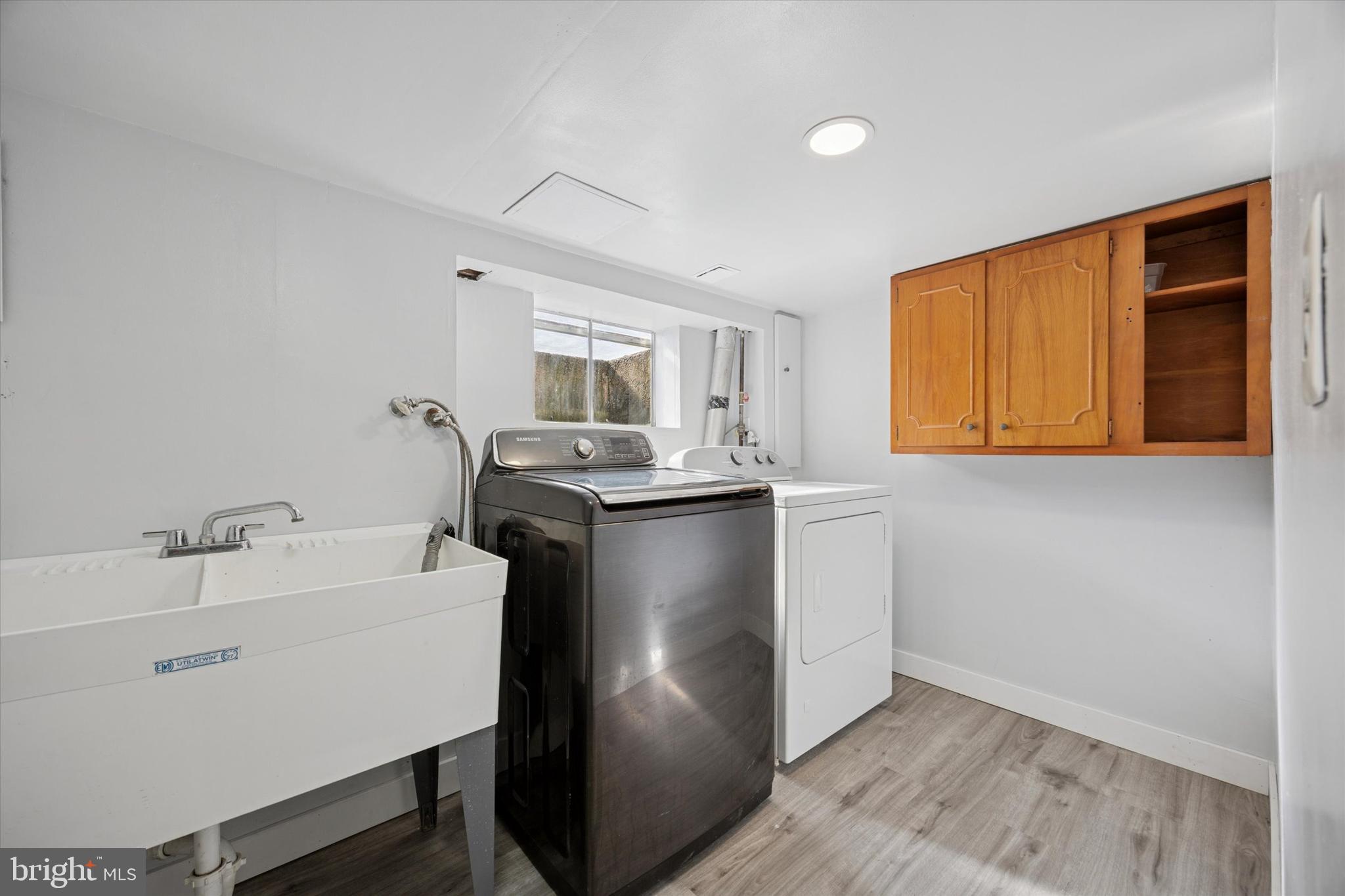 217 Windsor Avenue Upper Darby, PA 19082 - Photo 25 of 36 a kitchen with stainless steel appliances granite countertop a sink a stove and a refrigerator