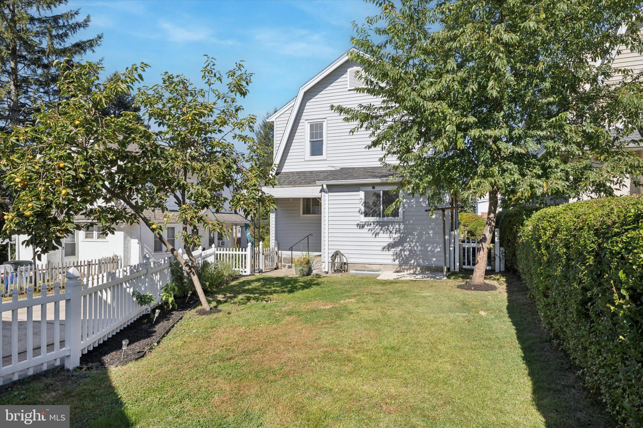 217 Windsor Avenue Upper Darby, PA 19082 - Photo 27 of 36 a front view of a house with a yard garage and outdoor seating