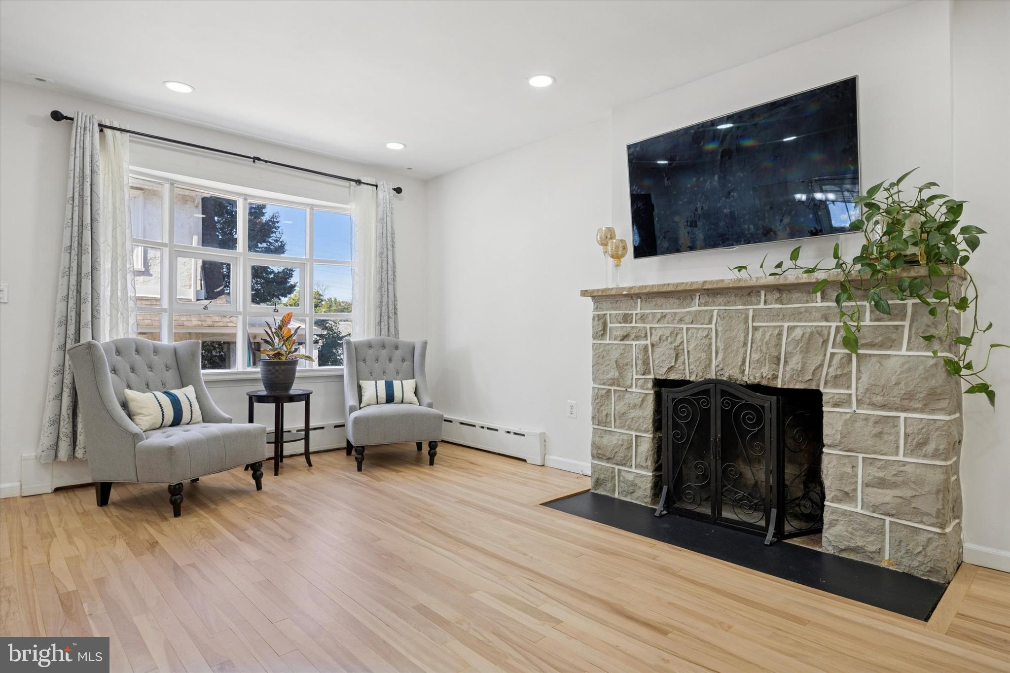 217 Windsor Avenue Upper Darby, PA 19082 - Photo 6 of 36 a living room with furniture and a fireplace