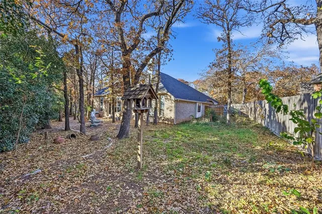 a wooden house with tall trees