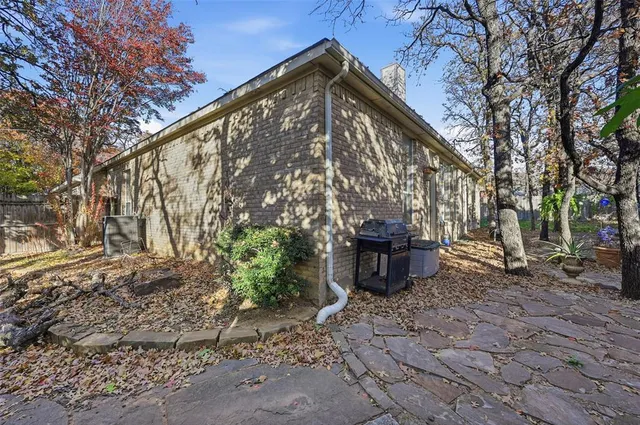 a backyard of a house with table and chairs
