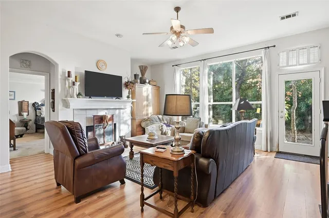 a living room with furniture a fireplace and a flat screen tv