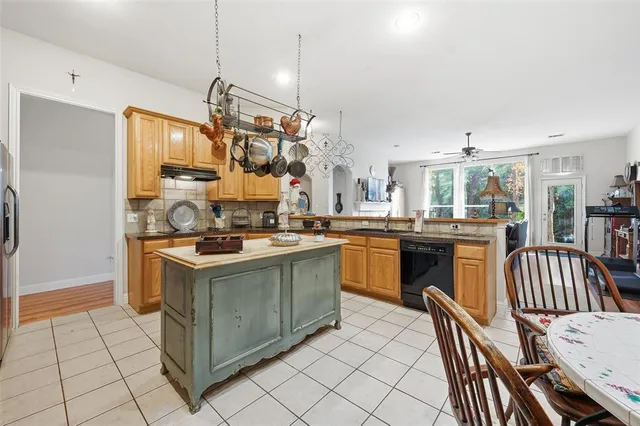 a kitchen with a stove and chairs