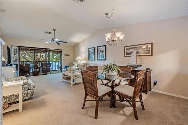 a view of a dining room with furniture and chandelier