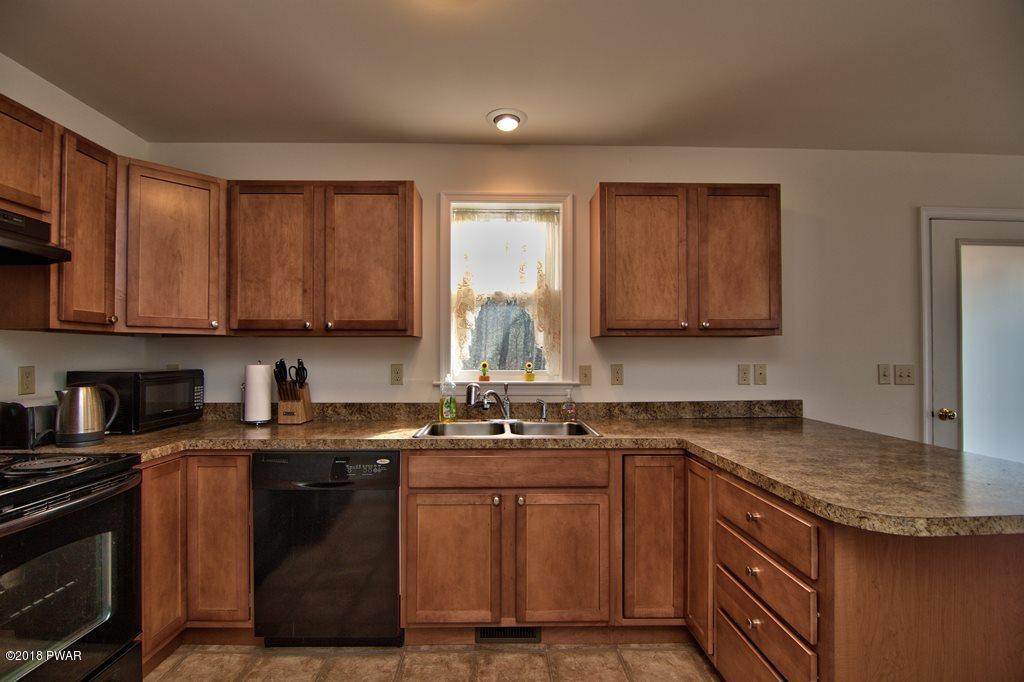 2312 Brookfield Road Lake Ariel, PA 18436 - Photo 5 of 26 a kitchen with stainless steel appliances granite countertop a sink stove and cabinets