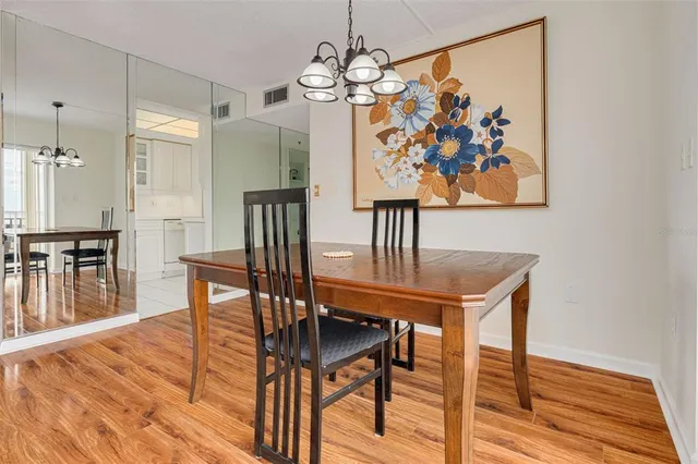 a large bed sitting in a bedroom next to a window and a chandelier