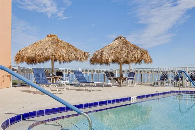 a living room with couch a dining table and chairs with wooden floor