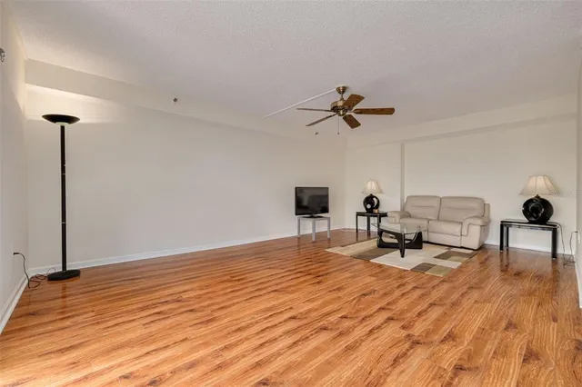 a view of a dining room with furniture wooden floor and a chandelier