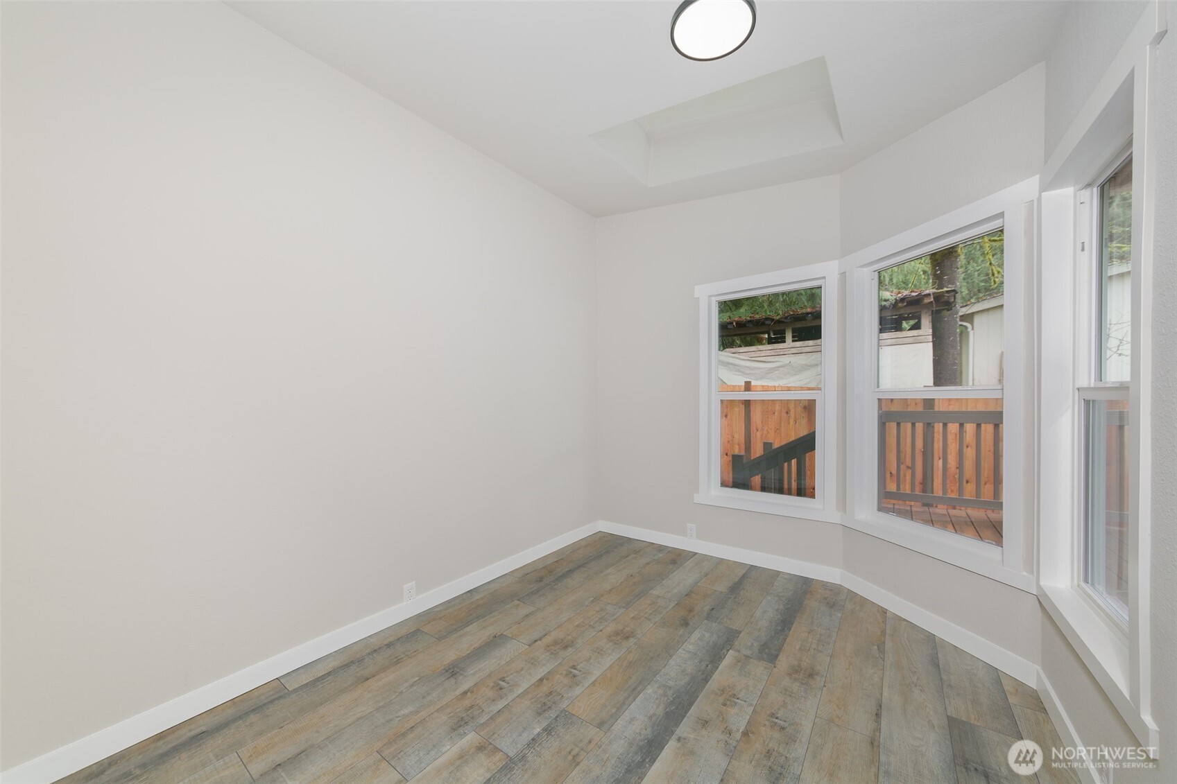 225 North Lake Roesiger Road Snohomish, WA 98290 - Photo 19 of 40 a view of an empty room with wooden floor and a window