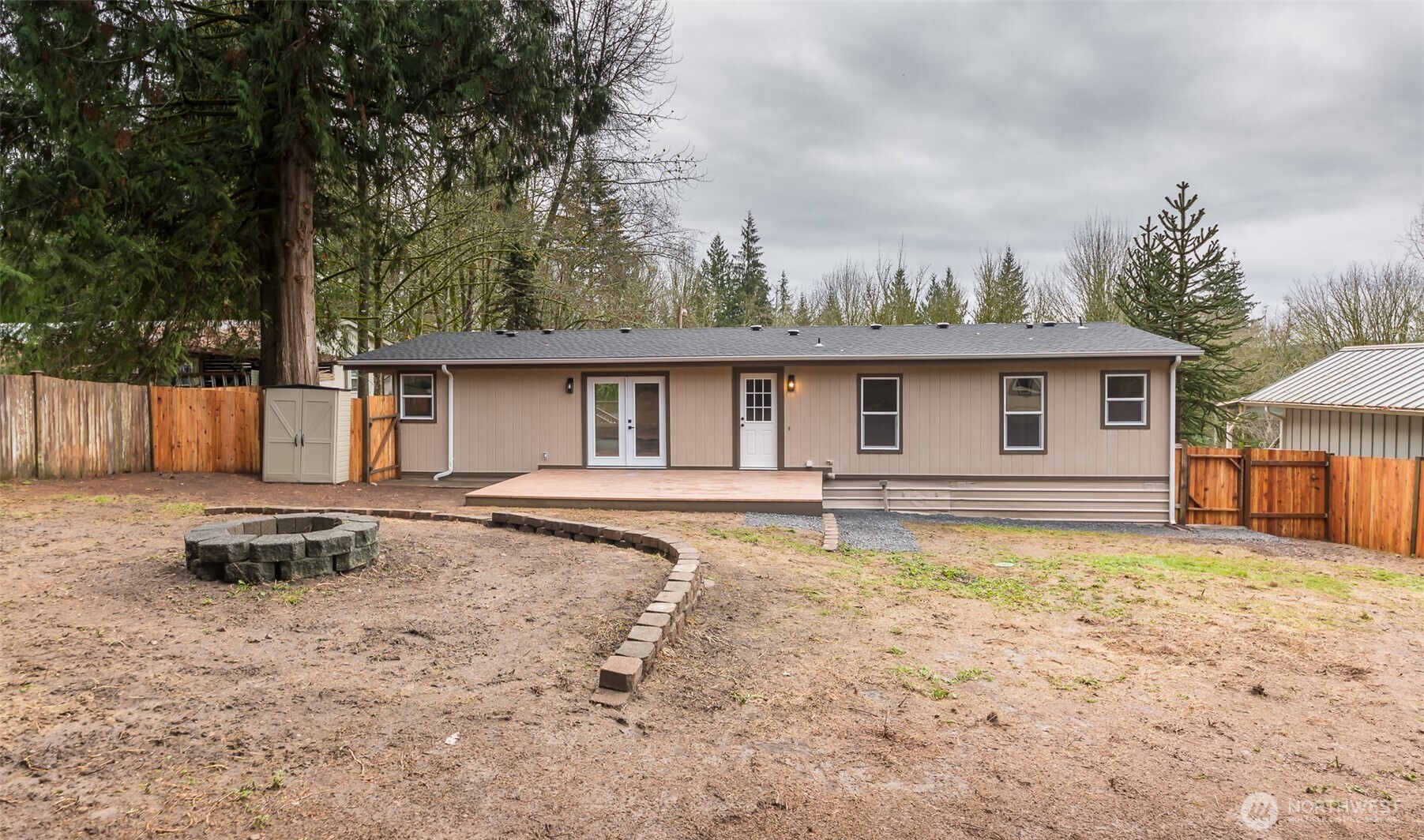 225 North Lake Roesiger Road Snohomish, WA 98290 - Photo 23 of 40 a backyard of a house with barbeque oven table and chairs