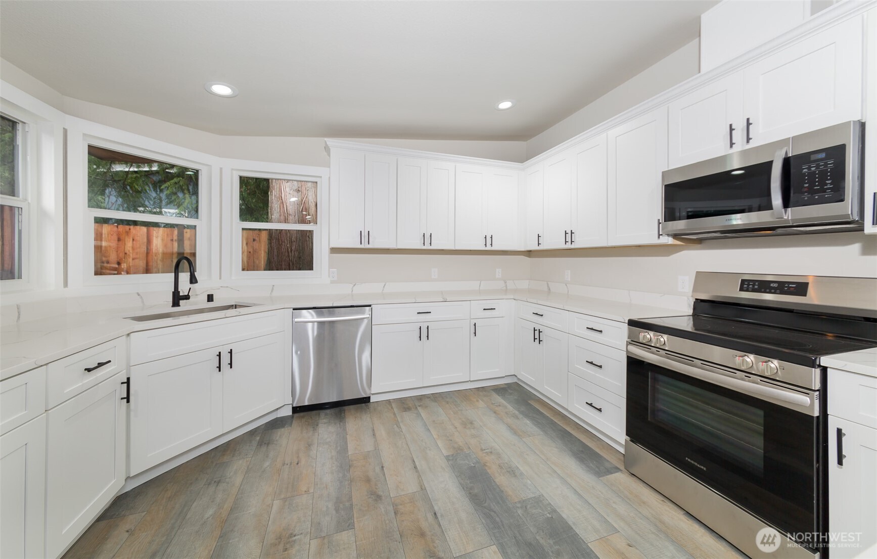225 North Lake Roesiger Road Snohomish, WA 98290 - Photo 3 of 40 a kitchen with appliances a sink cabinets and a window