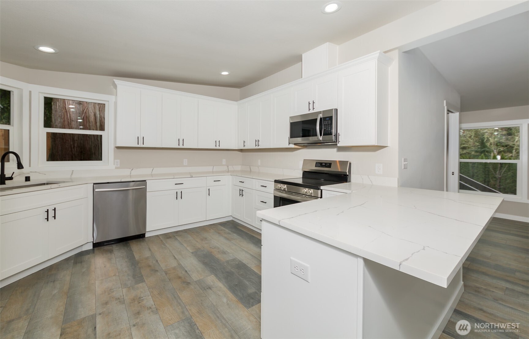 225 North Lake Roesiger Road Snohomish, WA 98290 - Photo 4 of 40 a kitchen with a sink a stove top oven and white kitchen