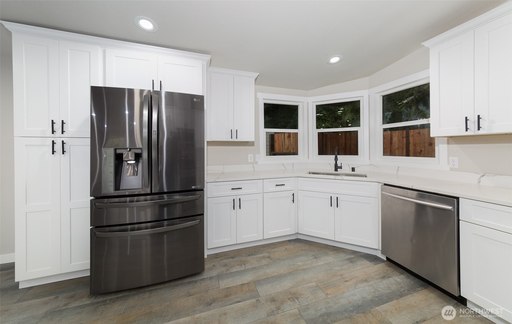 225 North Lake Roesiger Road Snohomish, WA 98290 - Photo 6 of 40 a kitchen with a refrigerator sink and cabinets