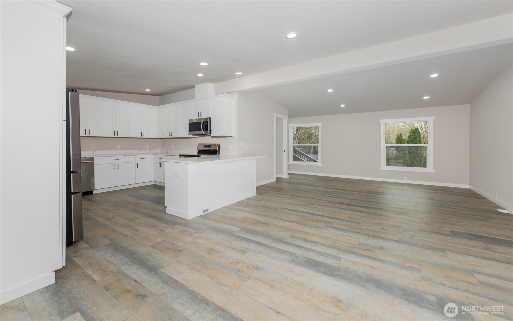 225 North Lake Roesiger Road Snohomish, WA 98290 - Photo 9 of 40 a view of kitchen with wooden floor and electronic appliances