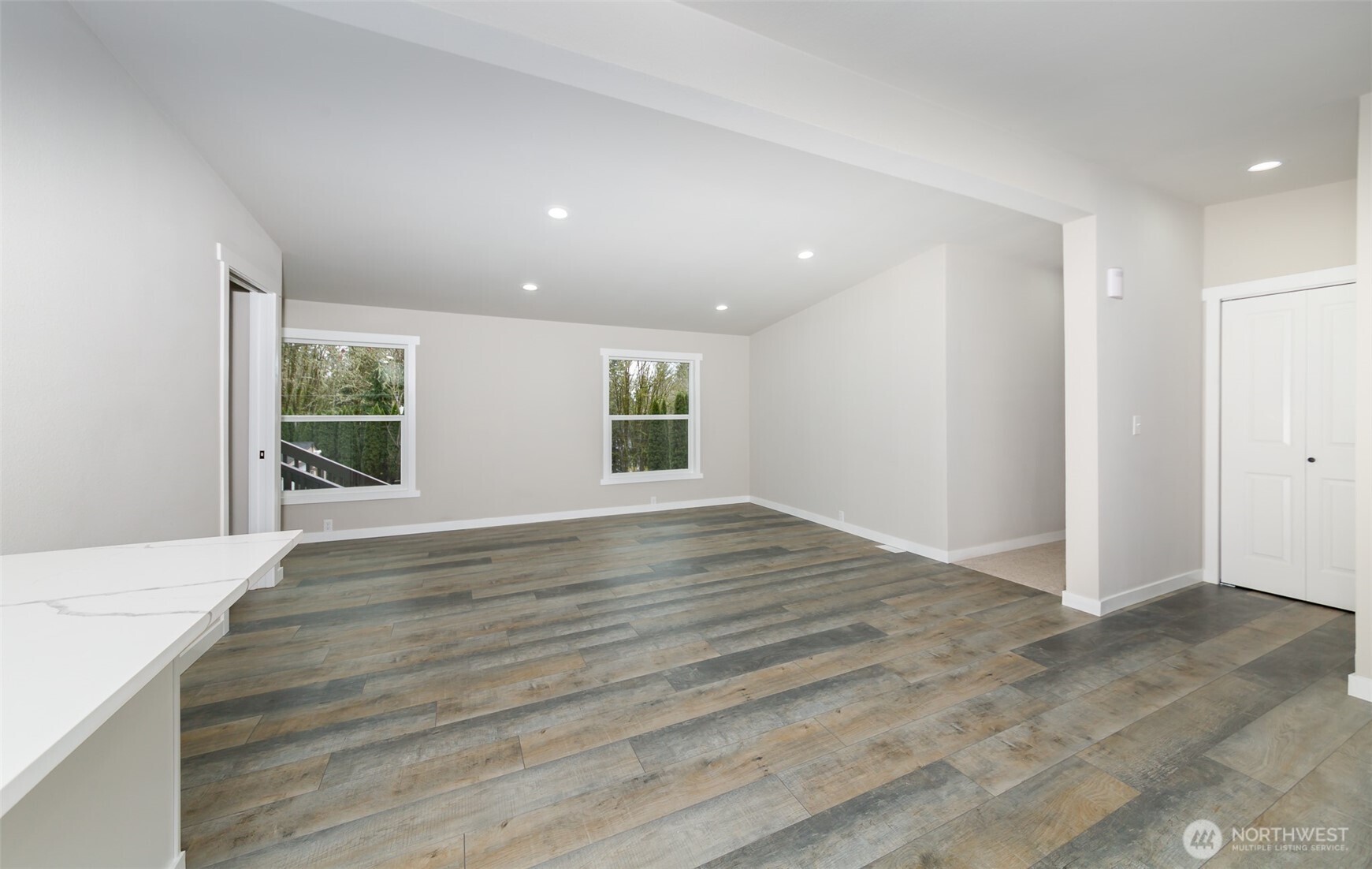 225 North Lake Roesiger Road Snohomish, WA 98290 - Photo 10 of 40 an empty room with wooden floor and windows