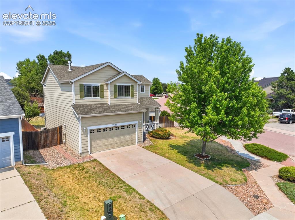 7904 Coffee Road Peyton, CO 80831 - Photo 38 of 48 Two-story residence featuring light beige siding and a two-car garage
