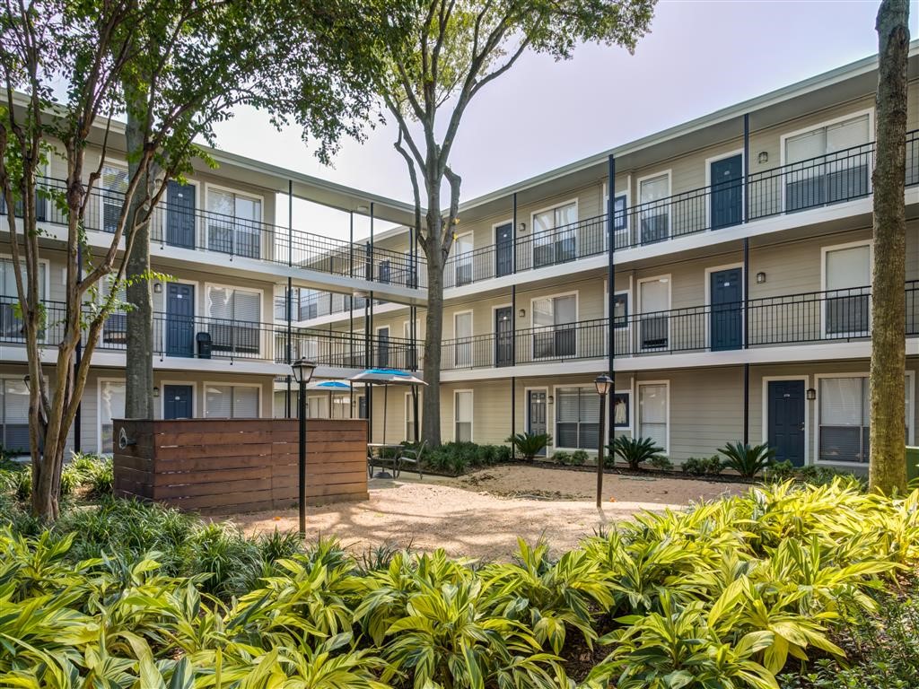 7315 Brompton Road, Unit 315B Houston, TX 77025 - Photo 10 of 13 a front view of a building with a garden
