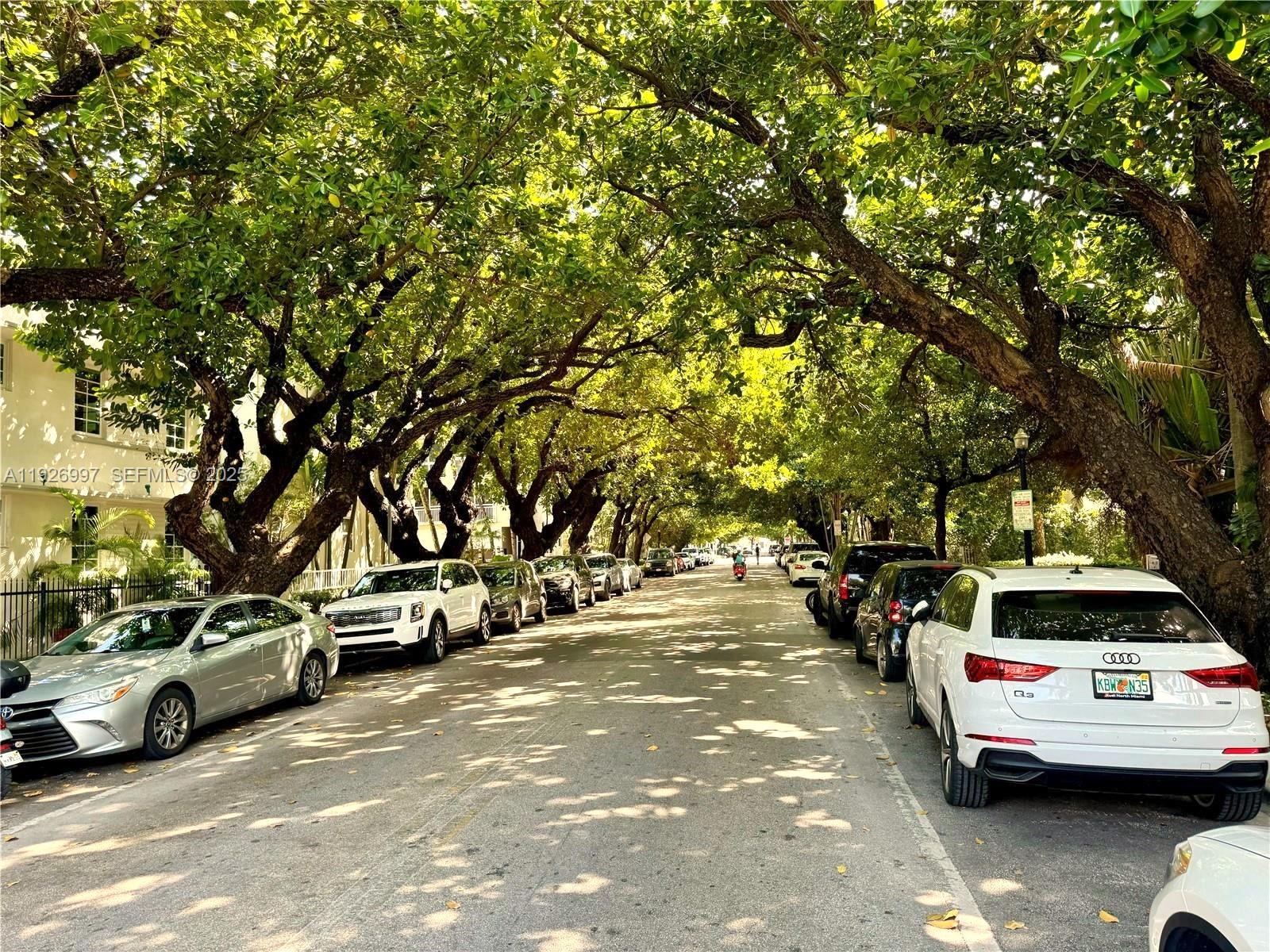 349 Meridian Avenue, Unit B202 Miami Beach, FL 33139 - Photo 1 of 20 a view of cars parked on the side of a street