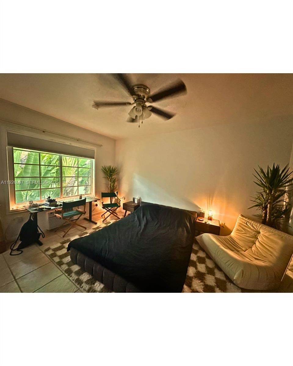 349 Meridian Avenue, Unit B202 Miami Beach, FL 33139 - Photo 14 of 20 a black leather couches in a living room with a large window