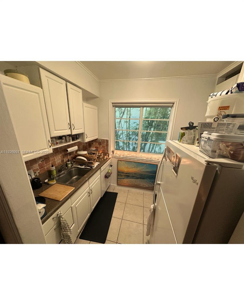 349 Meridian Avenue, Unit B202 Miami Beach, FL 33139 - Photo 18 of 20 a kitchen with a stove a sink and a window