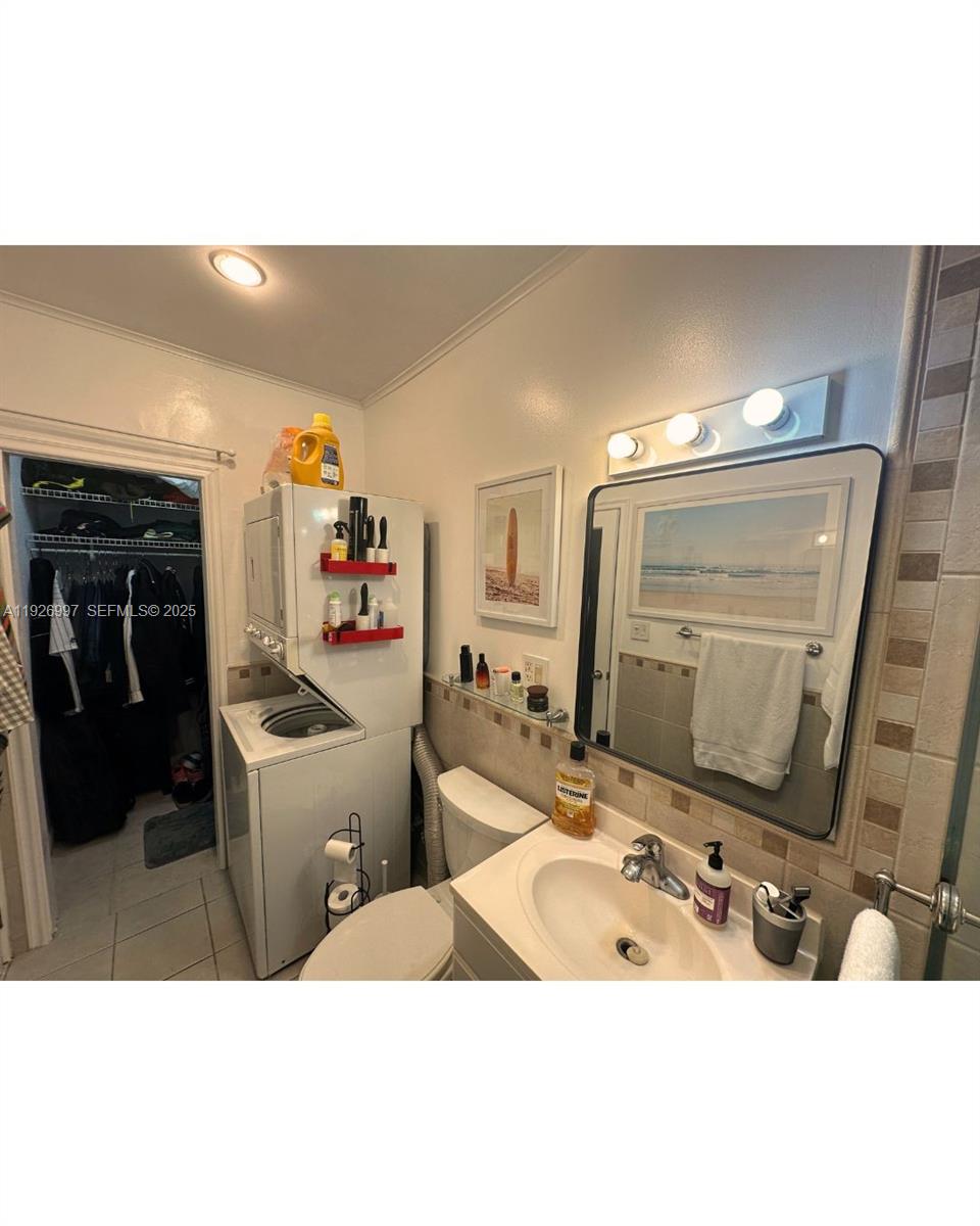 349 Meridian Avenue, Unit B202 Miami Beach, FL 33139 - Photo 20 of 20 a bathroom with a sink double vanity and a mirror