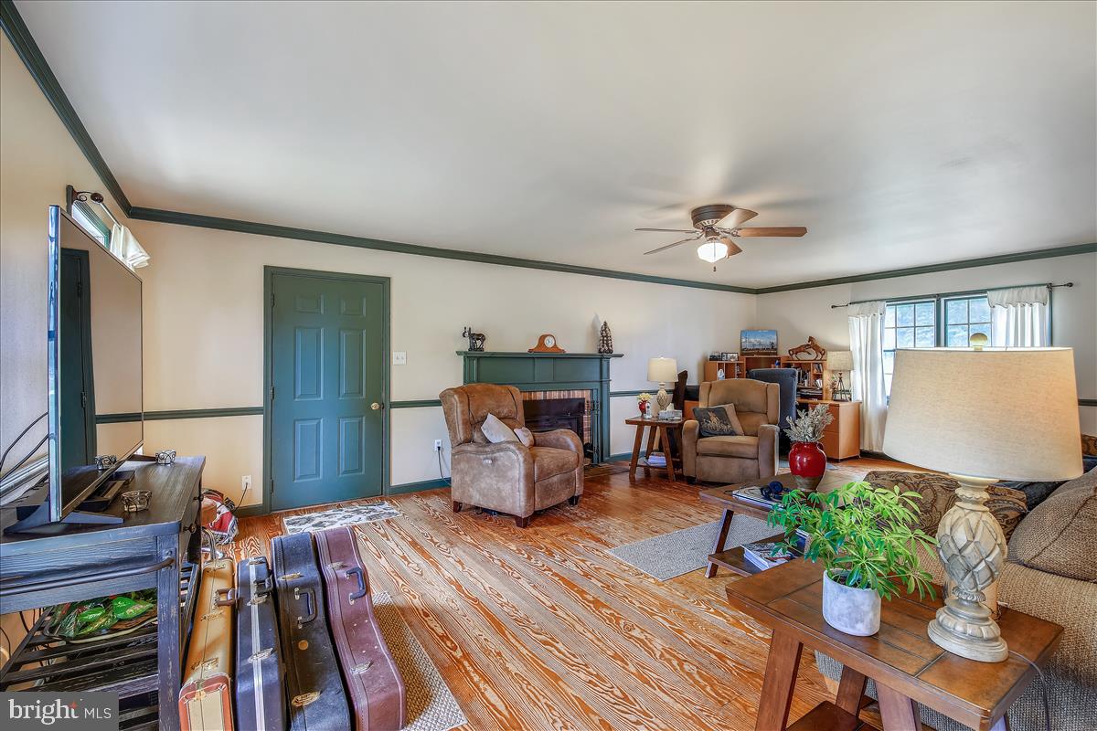 3949 Jesterville Road Tyaskin, MD 21865 - Photo 7 of 80 Living room with door to garage with FP