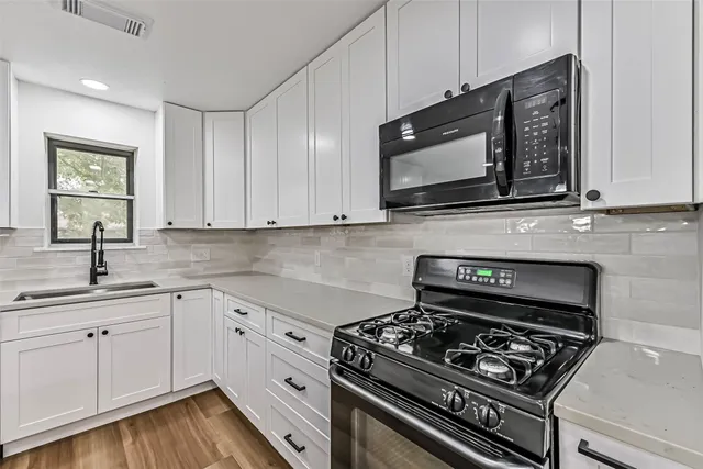 a kitchen with a stove and a microwave