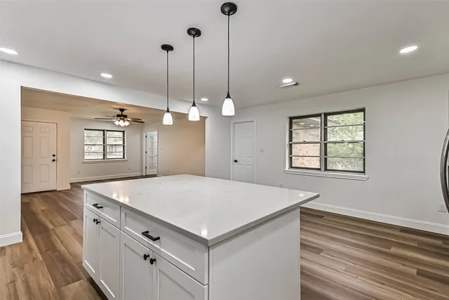 a kitchen that has a lot of center island in it