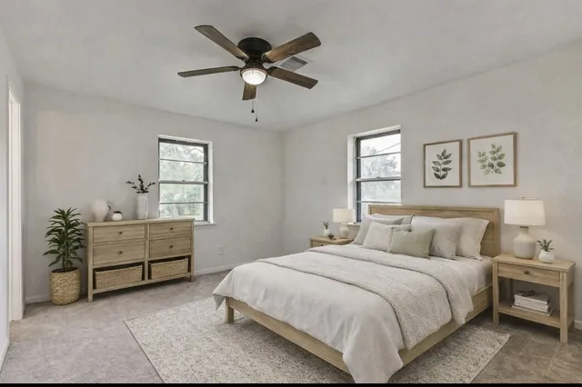 a bedroom with a bed and a chandelier fan