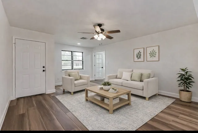 a living room with furniture and a large window