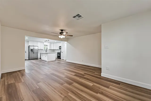 a view of kitchen and hallway with wooden floor