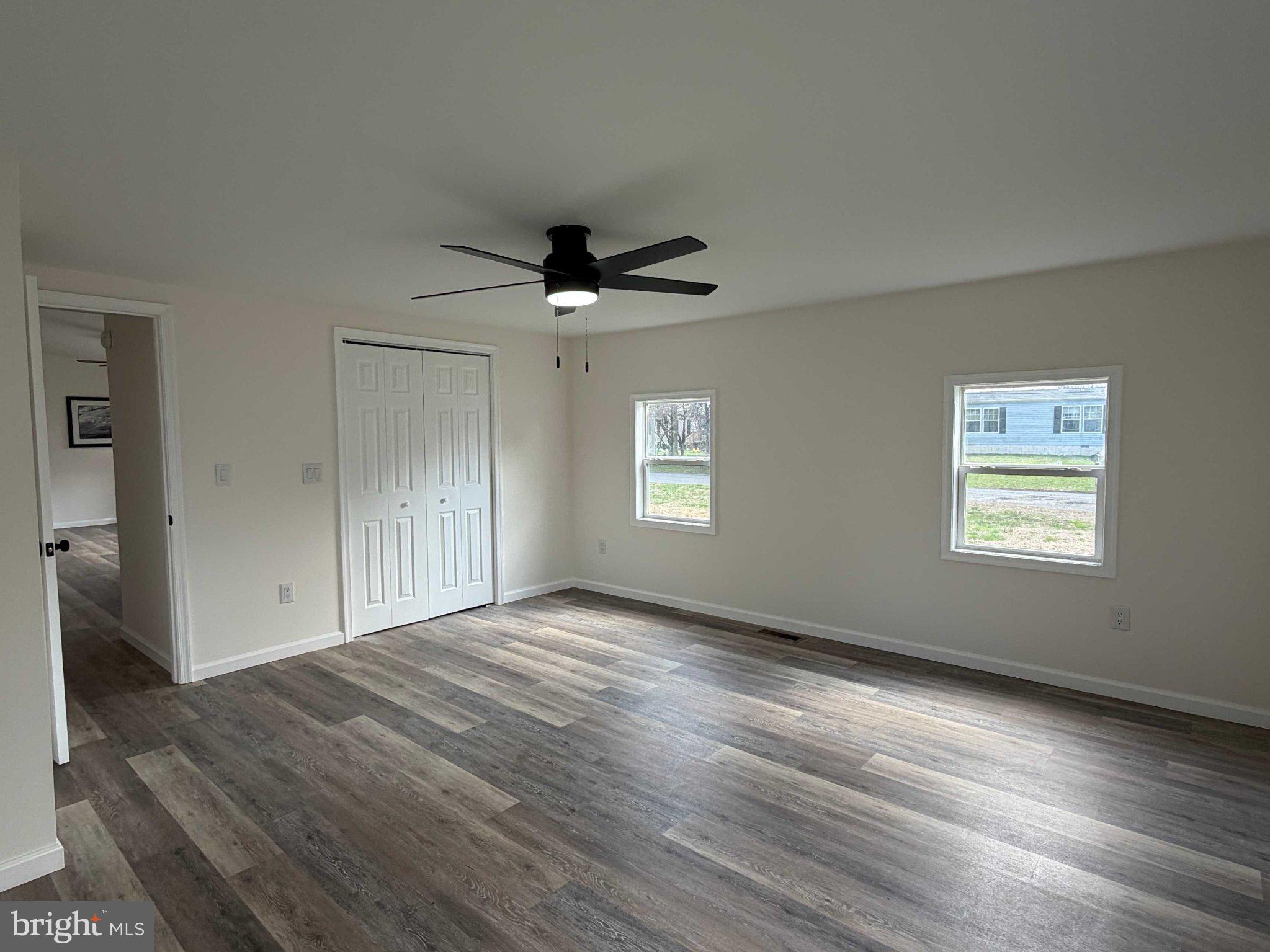 17335 Isdell Road Milford, DE 19963 - Photo 12 of 18 wooden floor in an empty room with a window