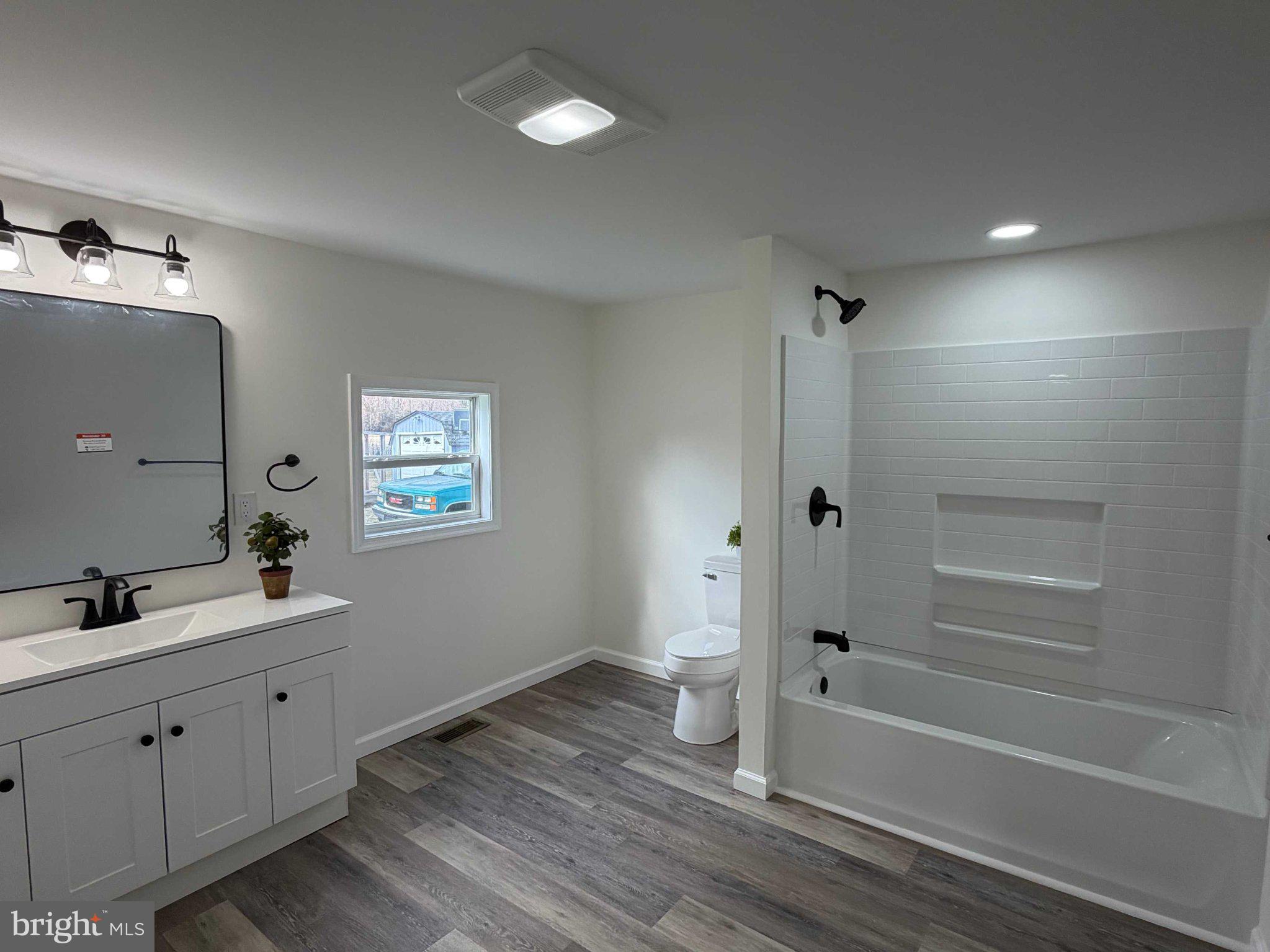 17335 Isdell Road Milford, DE 19963 - Photo 17 of 18 a bathroom with a sink and a mirror